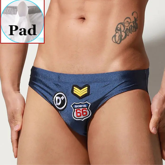 a sexy man in dark blue Men’s Officer on Duty Low Rise Swim Briefs with pad - pridevoyageshop.com - gay men’s sexy swim briefs, trunks, board shorts, and bikinis