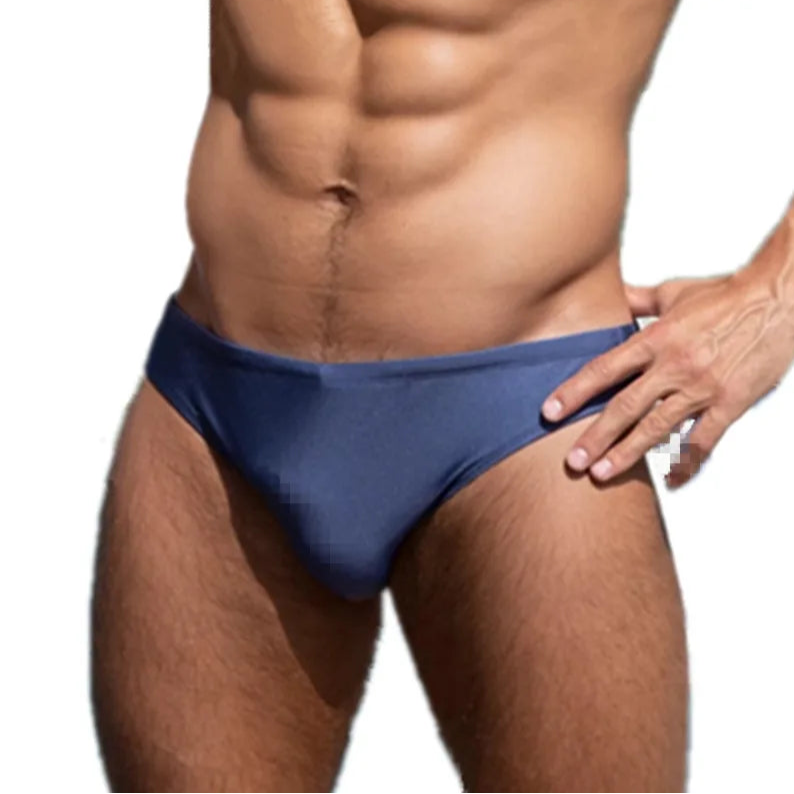 a sexy man in dark blue Men’s Tease-Me Minimal Swim Briefs - pridevoyageshop.com - gay men’s sexy swim briefs, trunks, board shorts, and bikinis