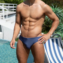 a sexy man in dark blue Men’s Tease-Me Minimal Swim Briefs - pridevoyageshop.com - gay men’s sexy swim briefs, trunks, board shorts, and bikinis