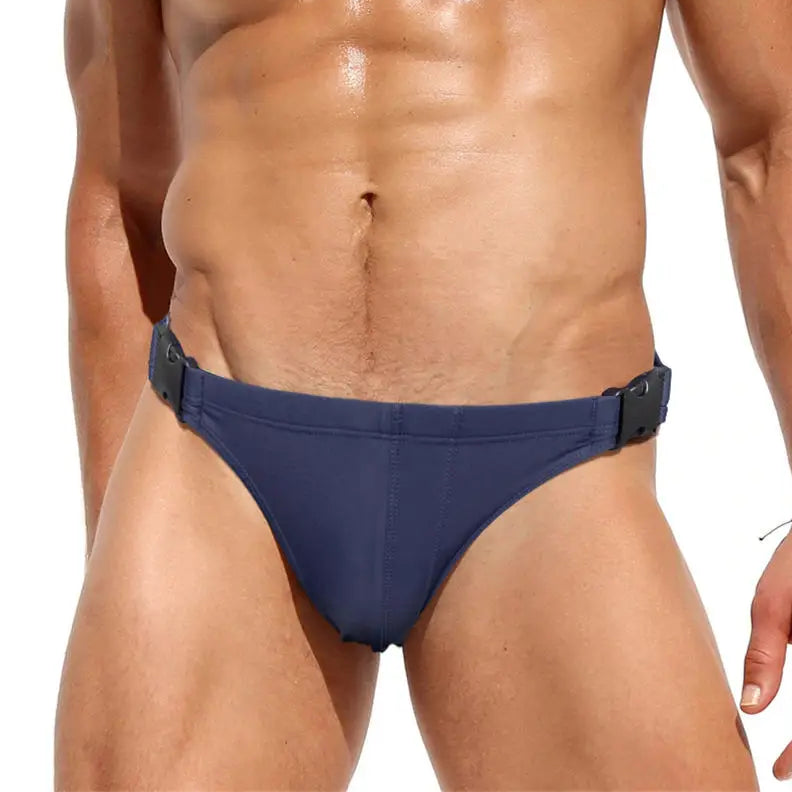 a sexy man in dark blue Men’s Unclip Me Double Buckle Swim Briefs - pridevoyageshop.com - gay men’s sexy swim briefs, trunks, board shorts, and bikinis