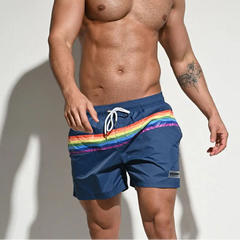 a sexy man in dark blue Men’s Werk the Rainbow Volley Pride Board Shorts – pridevoyageshop.com – gay men’s sexy swim briefs, trunks, board shorts, and bikinis
