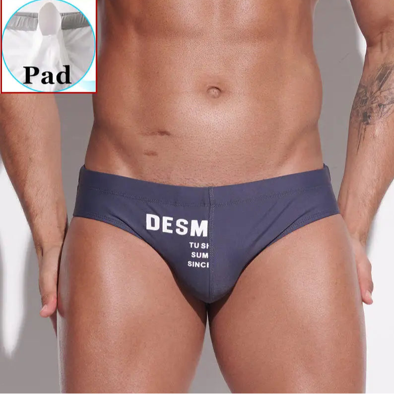 a sexy man in dark gray Men’s MVP Meatpack Swim Briefs with pad - pridevoyageshop.com - gay men’s sexy swim briefs, trunks, board shorts, and bikinis
