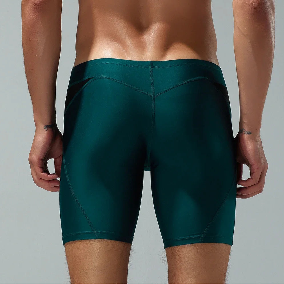 a sexy man in dark green Men’s Iron Vortex Compression Swim Shorts – pridevoyageshop.com – gay men’s sexy swim briefs, trunks, board shorts, and bikinis