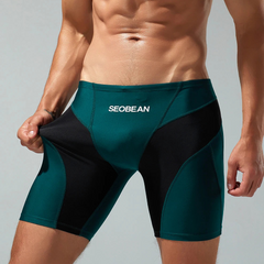 a sexy man in dark green Men’s Iron Vortex Compression Swim Shorts – pridevoyageshop.com – gay men’s sexy swim briefs, trunks, board shorts, and bikinis