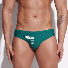 a sexy man in dark green Men’s MVP Meatpack Swim Briefs - pridevoyageshop.com - gay men’s sexy swim briefs, trunks, board shorts, and bikinis