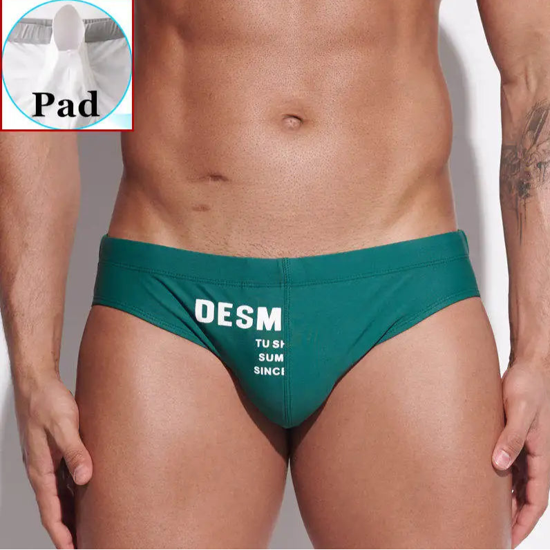a sexy man in dark green Men’s MVP Meatpack Swim Briefs with pad - pridevoyageshop.com - gay men’s sexy swim briefs, trunks, board shorts, and bikinis
