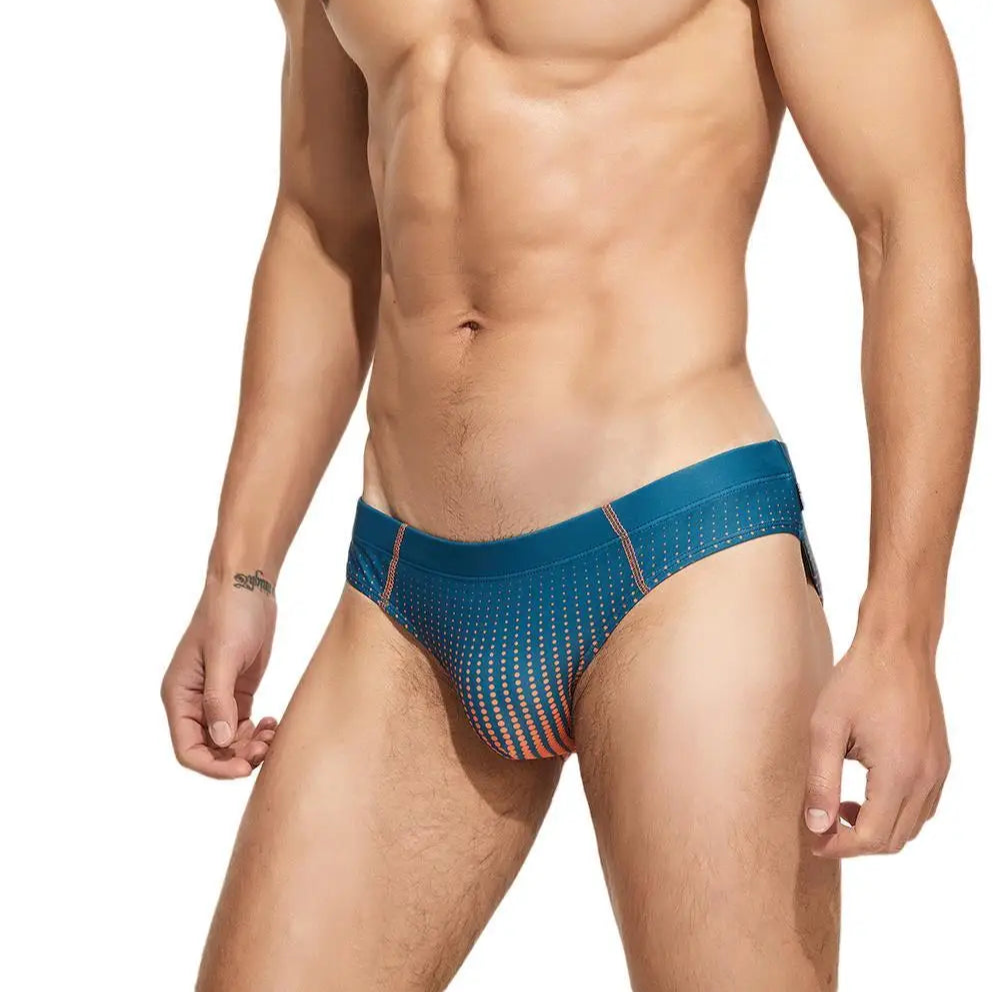 a sexy man in dark green Men’s Spank Me Dotty Swim Briefs - pridevoyageshop.com - gay men’s sexy swim briefs, trunks, board shorts, and bikinis