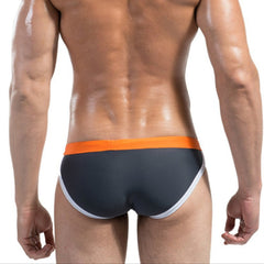 a sexy man in gray Desmiit Men’s Colorblock Speed Bulge Swim Briefs - pridevoyageshop.com - gay men’s sexy swim briefs, trunks, board shorts, and bikinis