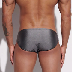 a sexy man in gray Desmiit Men’s Sleek Statement Swim Briefs - pridevoyageshop.com - gay men’s sexy swim briefs, trunks, board shorts, and bikinis