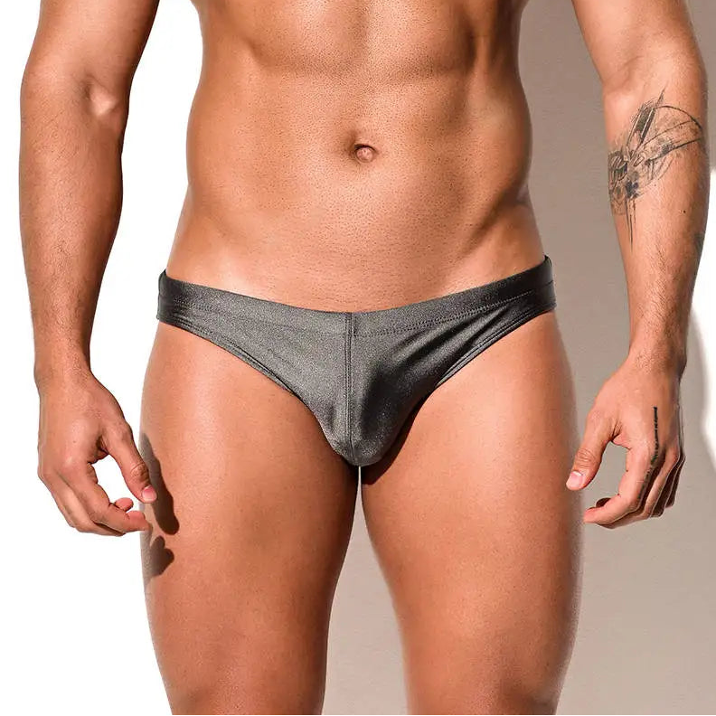a sexy man in gray Desmiit Men’s Trophy Cut Swim Briefs - pridevoyageshop.com - gay men’s sexy swim briefs, trunks, board shorts, and bikinis