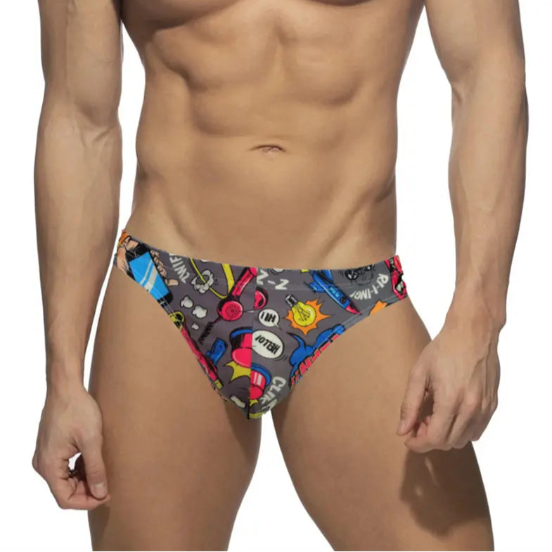 a sexy man in gray Men’s BOOM! Pop Art Thong Briefs - pridevoyageshop.com - gay men’s sexy swim briefs, trunks, board shorts, and bikinis