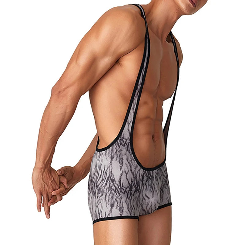 a sexy man in gray The Predator Singlet – pridevoyageshop.com – gay men’s harness, lingerie and fetish wear