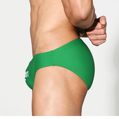 a sexy man in green Desmiit Men’s Brunch-Ready Bikini Swim Briefs - pridevoyageshop.com - gay men’s sexy swim briefs, trunks, board shorts, and bikinis