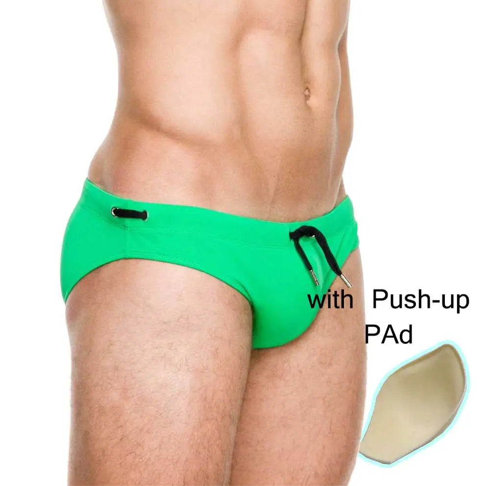 a sexy man in green Men’s Beach Brat Swim Briefs with pad - pridevoyageshop.com - gay men’s sexy swim briefs, trunks, board shorts, and bikinis