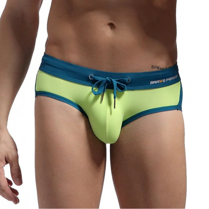 a sexy man in green Men’s Brave Package Swim Briefs - pridevoyageshop.com - gay men’s sexy swim briefs, trunks, board shorts, and bikinis