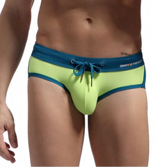 a sexy man in green Men’s Brave Package Swim Briefs - pridevoyageshop.com - gay men’s sexy swim briefs, trunks, board shorts, and bikinis