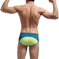a sexy man in green Men’s Brave Package Swim Briefs - pridevoyageshop.com - gay men’s sexy swim briefs, trunks, board shorts, and bikinis
