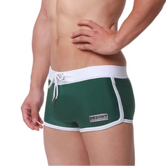 a sexy man in green Men’s Circuit Beat Low Rise Swim Trunks - pridevoyageshop.com - gay men’s sexy swim briefs, trunks, board shorts, and bikinis