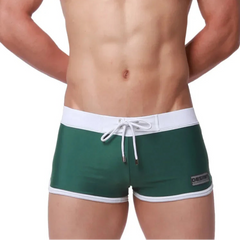 a sexy man in green Men’s Circuit Beat Low Rise Swim Trunks - pridevoyageshop.com - gay men’s sexy swim briefs, trunks, board shorts, and bikinis