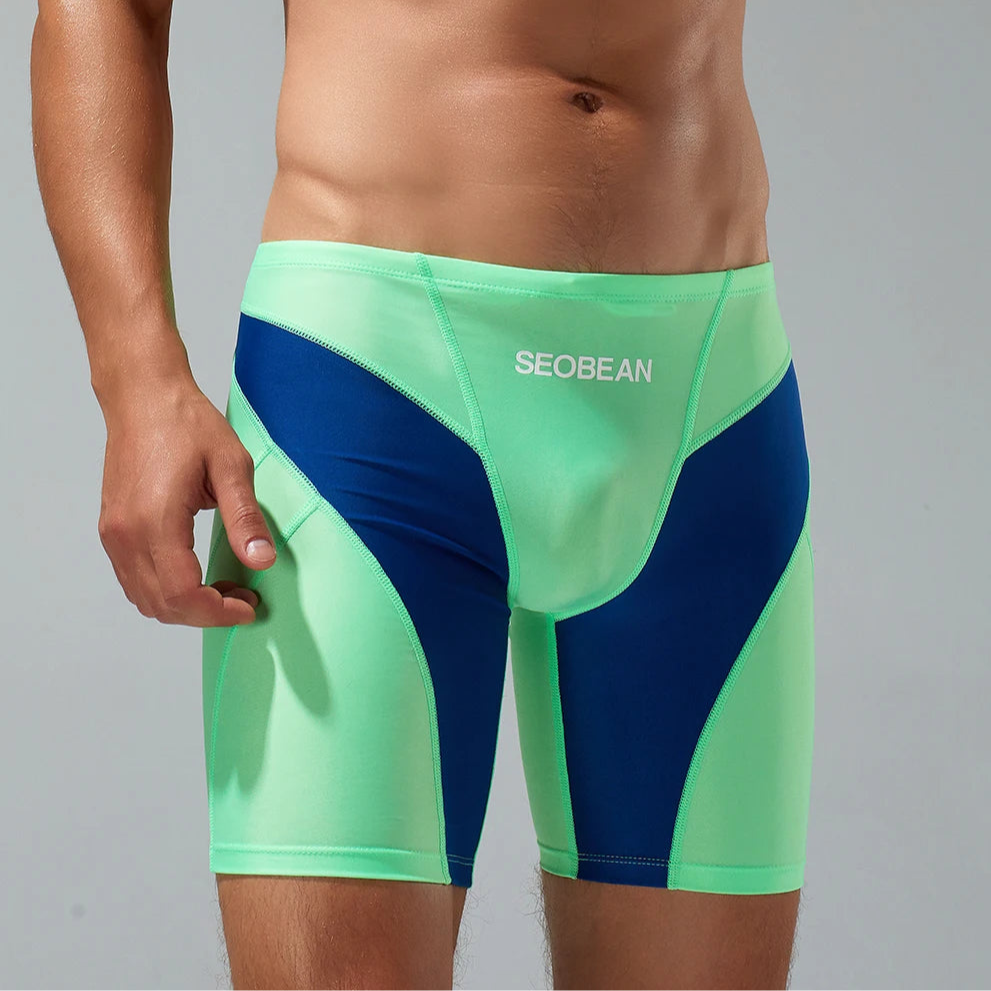 a sexy man in green Men’s Iron Vortex Compression Swim Shorts – pridevoyageshop.com – gay men’s sexy swim briefs, trunks, board shorts, and bikinis