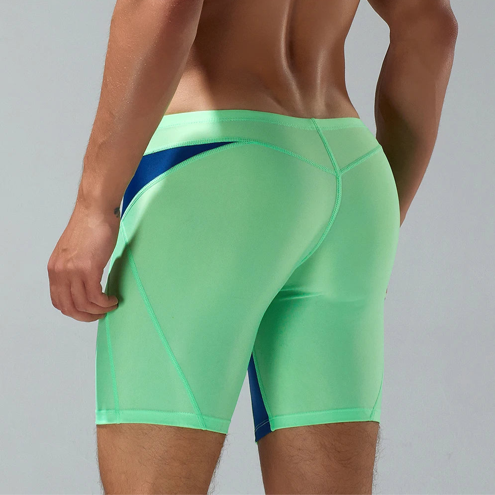 a sexy man in green Men’s Iron Vortex Compression Swim Shorts – pridevoyageshop.com – gay men’s sexy swim briefs, trunks, board shorts, and bikinis
