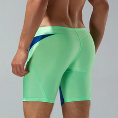 a sexy man in green Men’s Iron Vortex Compression Swim Shorts – pridevoyageshop.com – gay men’s sexy swim briefs, trunks, board shorts, and bikinis