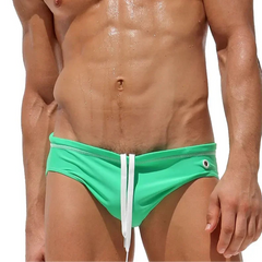 a sexy man in green Men’s Wettest Secret Swim BriefsMen’s Wettest Secret Swim Briefs - pridevoyageshop.com - gay men’s sexy swim briefs, trunks, board shorts, and bikinis