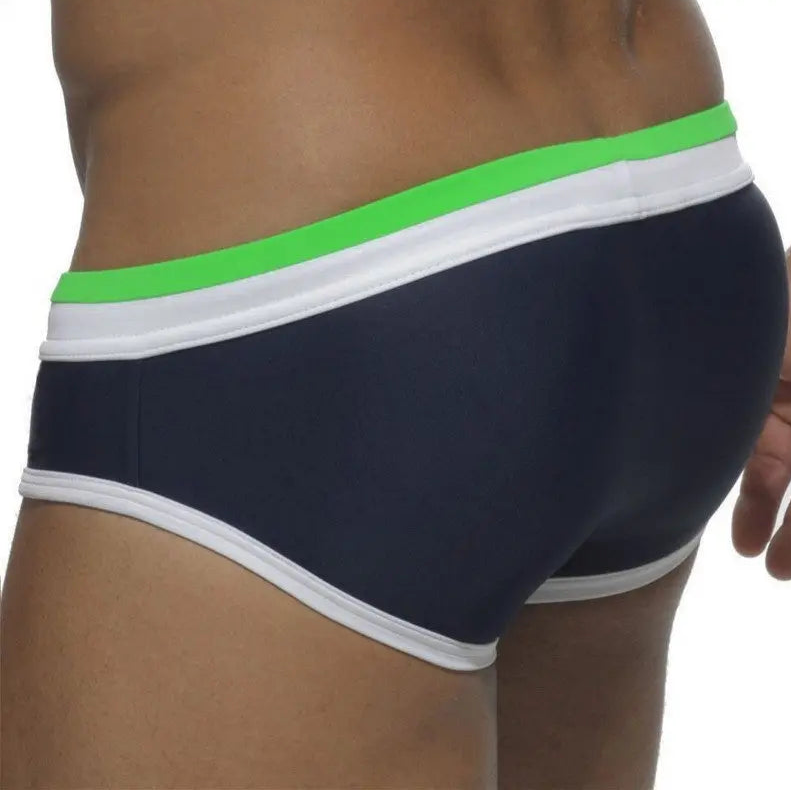 a sexy man in green and dark blue Men’s Split Decision Bulge Swim Briefs - pridevoyageshop.com - gay men’s sexy swim briefs, trunks, board shorts, and bikinis
