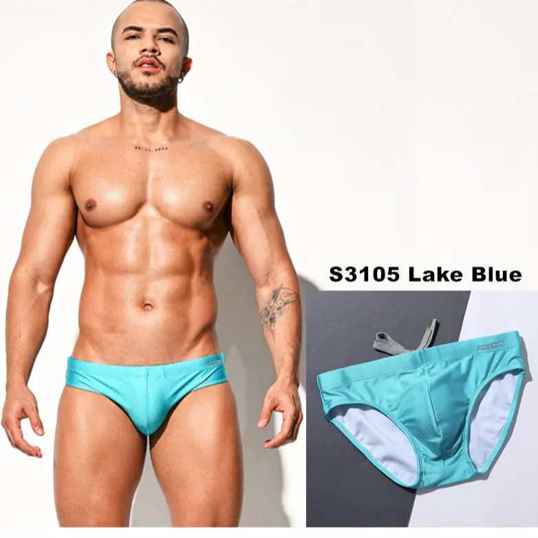a sexy man in lake blue Men’s Pool Plumper Padded Swim Briefs - pridevoyageshop.com - gay men’s sexy swim briefs, trunks, board shorts, and bikinis
