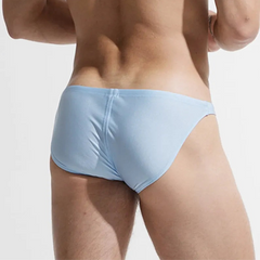 a sexy man in light blue Desmiit Men’s Below Sea Level Bikini Swim Briefs - pridevoyageshop.com - gay men’s sexy swim briefs, trunks, board shorts, and bikinis