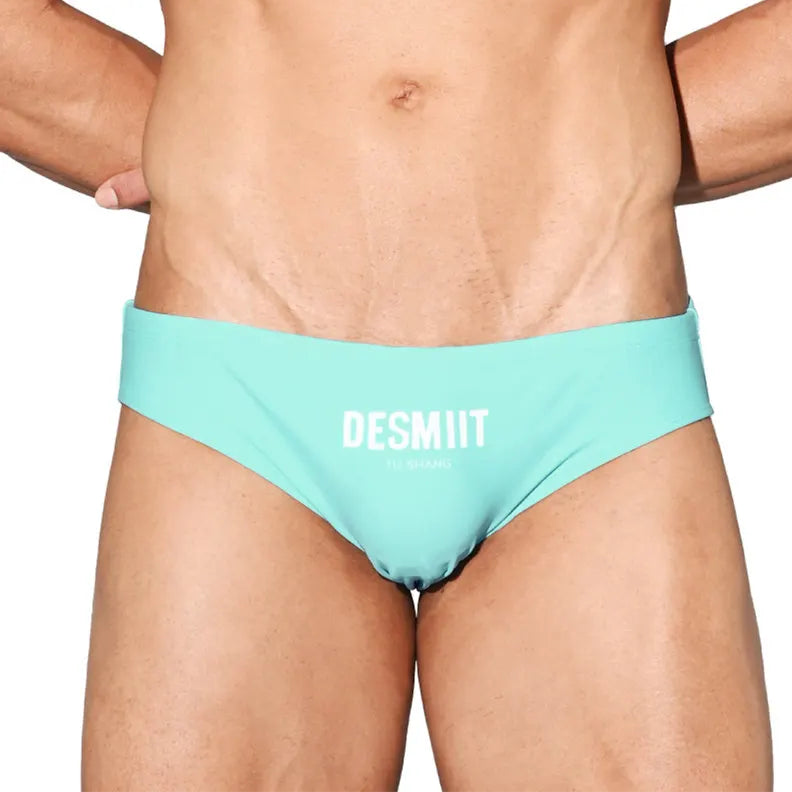 a sexy man in light blue Desmiit Men’s Brunch-Ready Bikini Swim Briefs - pridevoyageshop.com - gay men’s sexy swim briefs, trunks, board shorts, and bikinis