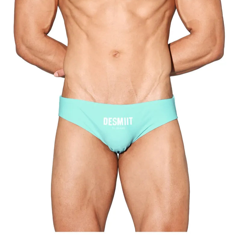 a sexy man in light blue Desmiit Men’s Brunch-Ready Bikini Swim Briefs - pridevoyageshop.com - gay men’s sexy swim briefs, trunks, board shorts, and bikinis