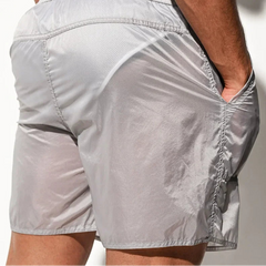 a sexy man in light gray Men’s Cellblock Sheen Swim Short – pridevoyageshop.com – gay men’s sexy swim briefs, trunks, board shorts, and bikinis