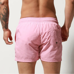 a sexy man in light pink Desmiit Men’s Circuit Signal Swim Short – pridevoyageshop.com – gay men’s sexy swim briefs, trunks, board shorts, and bikinis