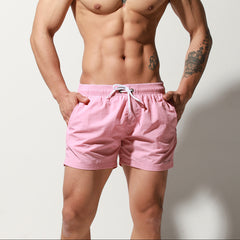 a sexy man in light pink Desmiit Men’s Circuit Signal Swim Short – pridevoyageshop.com – gay men’s sexy swim briefs, trunks, board shorts, and bikinis