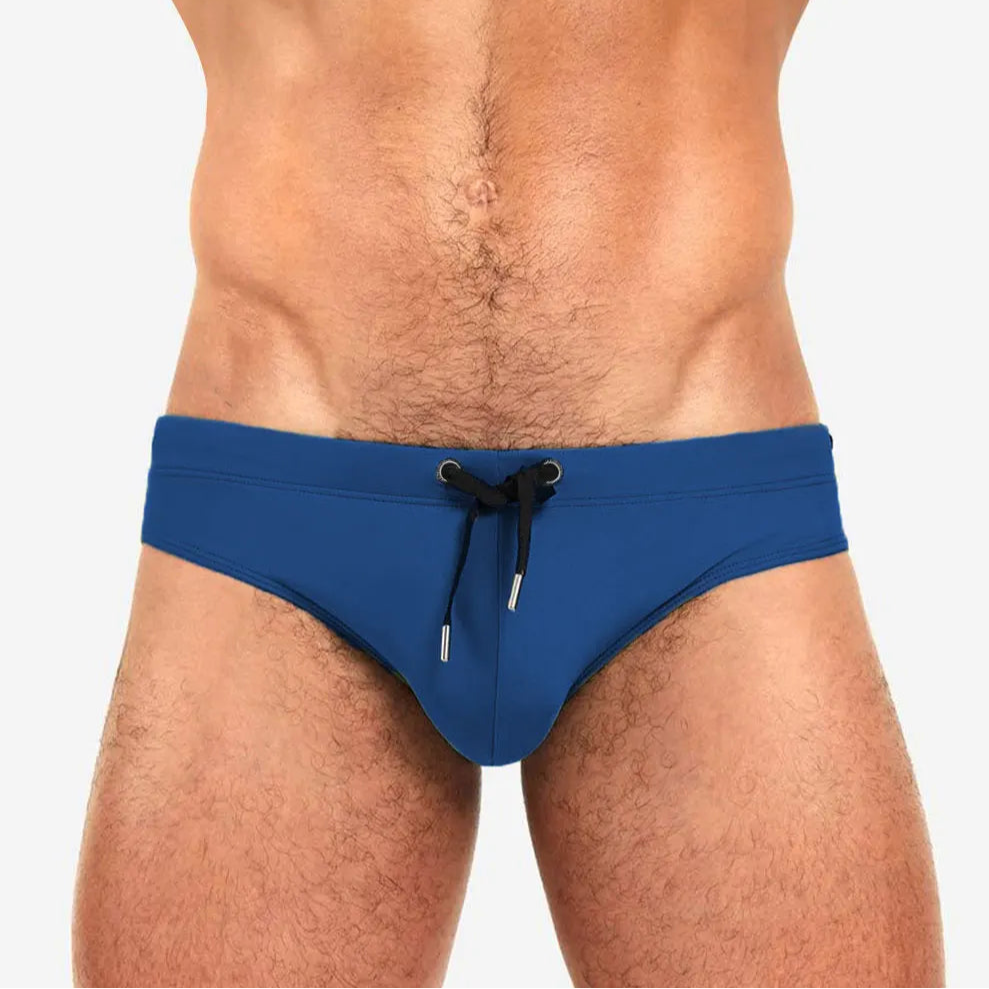 a sexy man in navy Men’s Beach Brat Swim Briefs - pridevoyageshop.com - gay men’s sexy swim briefs, trunks, board shorts, and bikinis