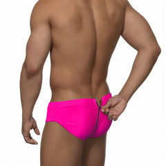 a sexy man in neon fushia Men's Unzip Me Daddy Swim Briefs - pridevoyageshop.com - gay men’s sexy swim briefs, trunks, board shorts, and bikinis