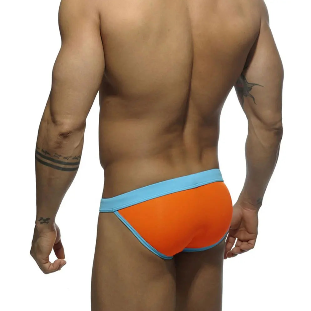a sexy man in orange Men’s Forbidden Fruit Bikini Swim Briefs - pridevoyageshop.com - gay men’s sexy swim briefs, trunks, board shorts, and bikinis