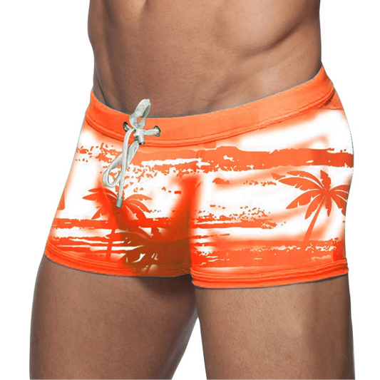 a sexy man in orange Men’s Holiday Hung Swim Trunks- pridevoyageshop.com - gay men’s sexy swim briefs, trunks, board shorts, and bikinis