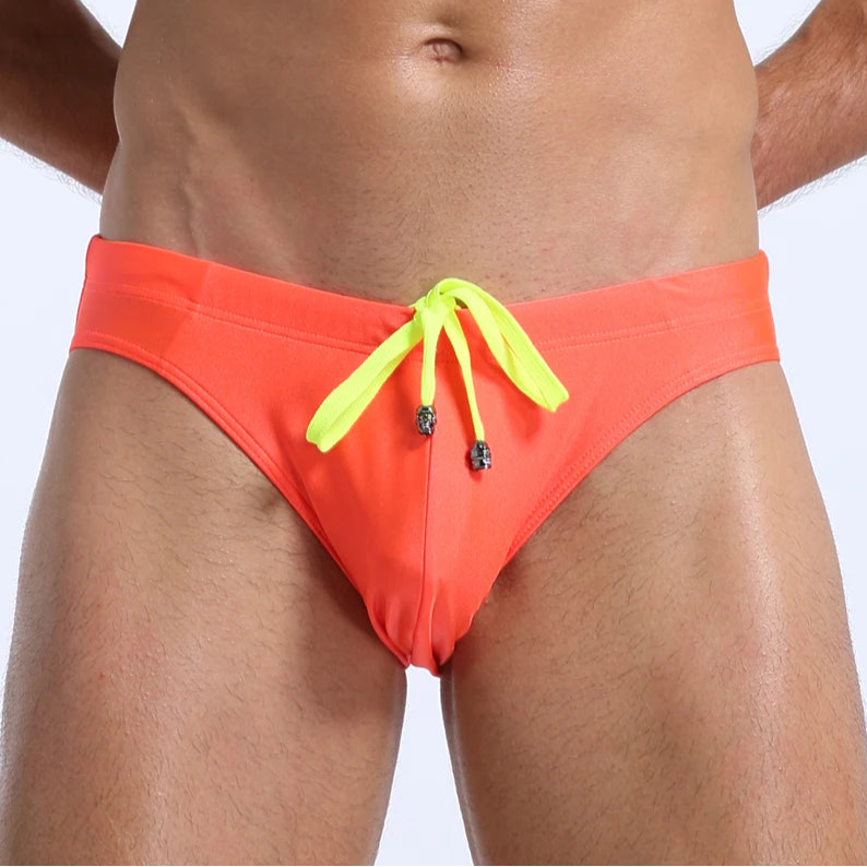 a sexy man in orange Men's Killer Bulge Swim Brief - pridevoyageshop.com - gay men’s sexy swim briefs, trunks, board shorts, and bikinis