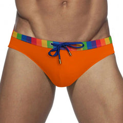 a sexy man in orange Men’s Pride Patrol Rainbow Band Swim Briefs - pridevoyageshop.com - gay men’s sexy swim briefs, trunks, board shorts, and bikinis