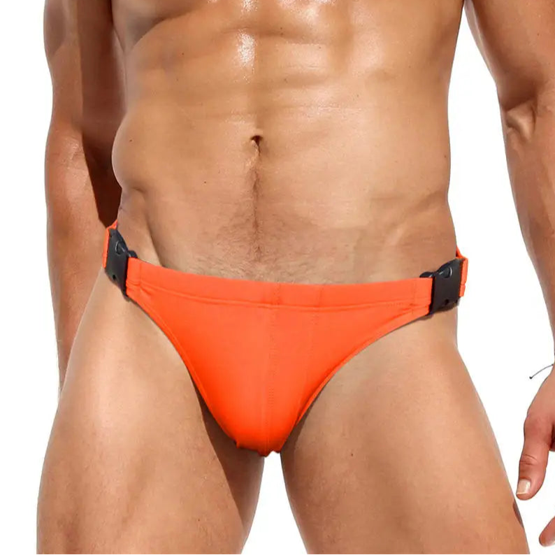 a sexy man in orange Men’s Unclip Me Double Buckle Swim Briefs - pridevoyageshop.com - gay men’s sexy swim briefs, trunks, board shorts, and bikinis