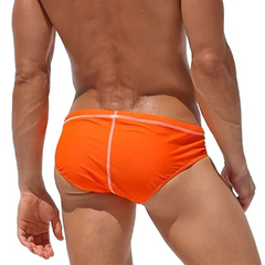 a sexy man in orange Men’s Wettest Secret Swim BriefsMen’s Wettest Secret Swim Briefs - pridevoyageshop.com - gay men’s sexy swim briefs, trunks, board shorts, and bikinis