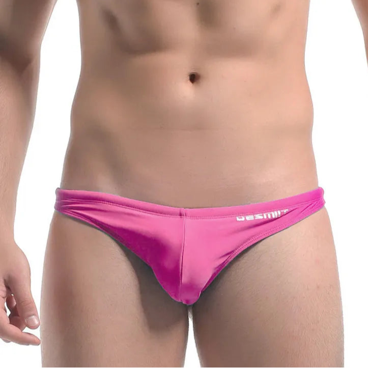 a sexy man in pink DESMIIT Men’s Candy Drop Micro Bikini Swim Briefs - pridevoyageshop.com - gay men’s sexy swim briefs, trunks, board shorts, and bikinis