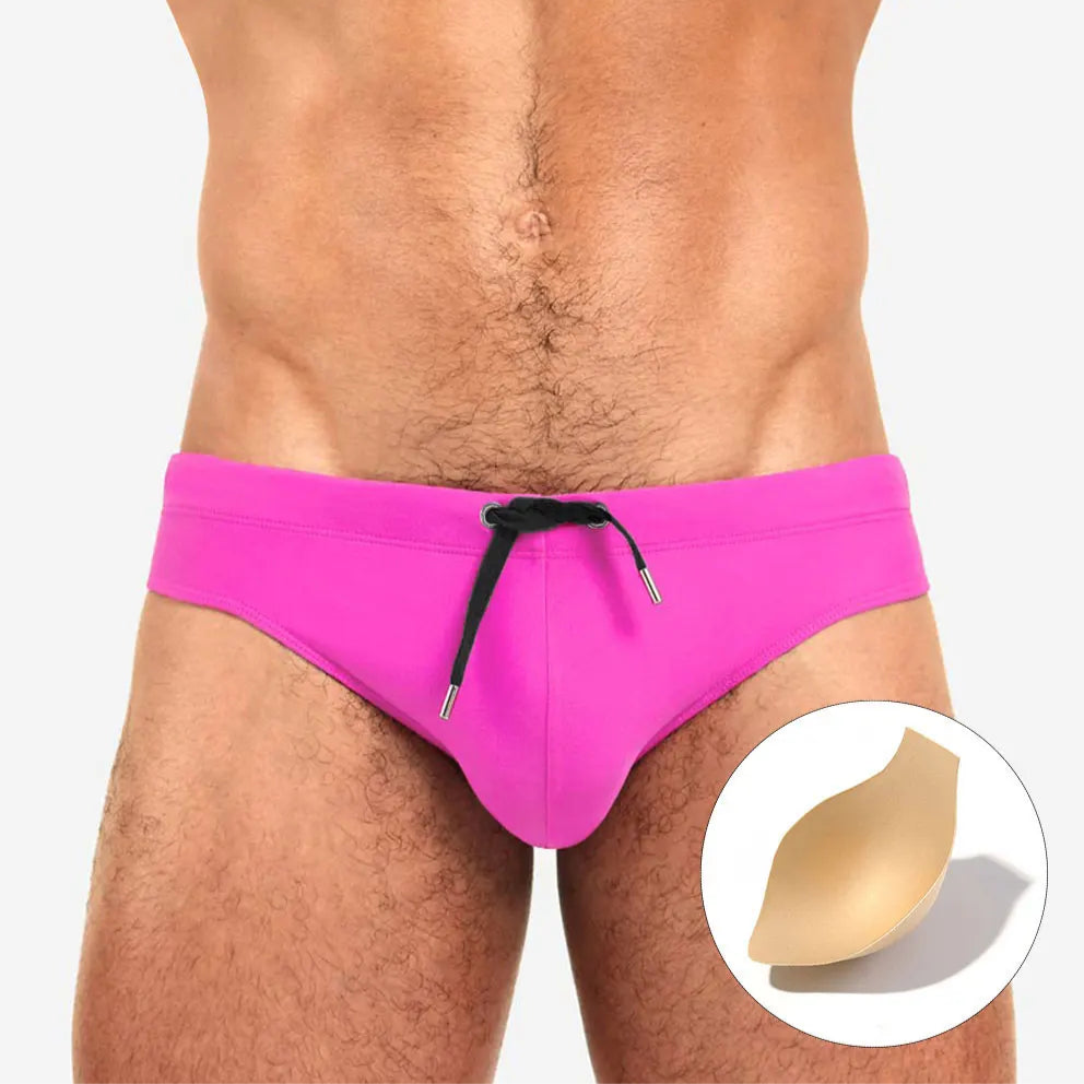 a sexy man in pink Men’s Beach Brat Swim Briefs with pad - pridevoyageshop.com - gay men’s sexy swim briefs, trunks, board shorts, and bikinis