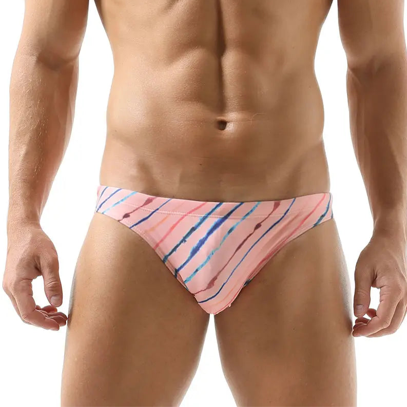 a sexy man in pink Men’s Rainbow Ripple Pride Swim Briefs - pridevoyageshop.com - gay men’s sexy swim briefs, trunks, board shorts, and bikinis