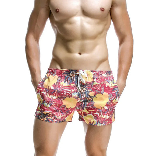 a sexy man in pink Men’s Tap-Ready Tides Swim Beach Surf Shorts – pridevoyageshop.com – gay men’s sexy swim briefs, trunks, board shorts, and bikinis