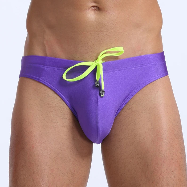 a sexy man in purple Men's Killer Bulge Swim Brief - pridevoyageshop.com - gay men’s sexy swim briefs, trunks, board shorts, and bikinis