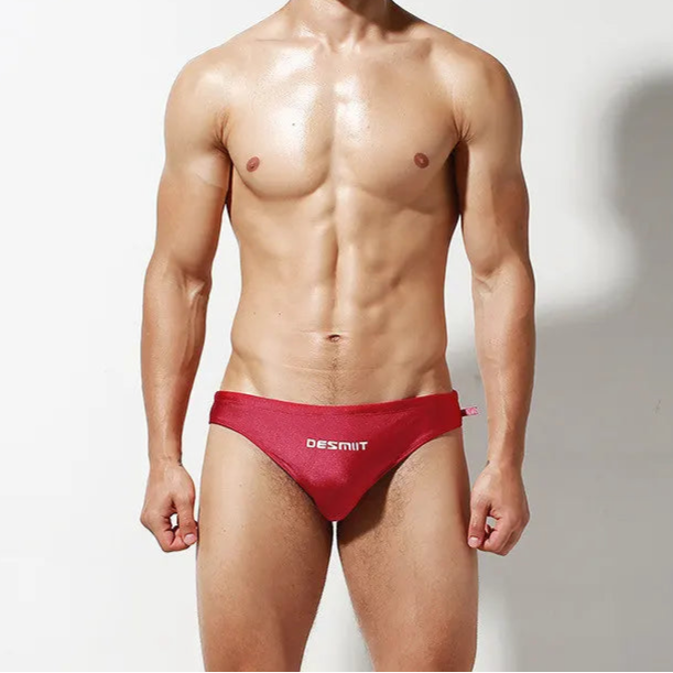 a sexy man in red Desmiit Men’s Hung Tight Swim Briefs - pridevoyageshop.com - gay men’s sexy swim briefs, trunks, board shorts, and bikinis
