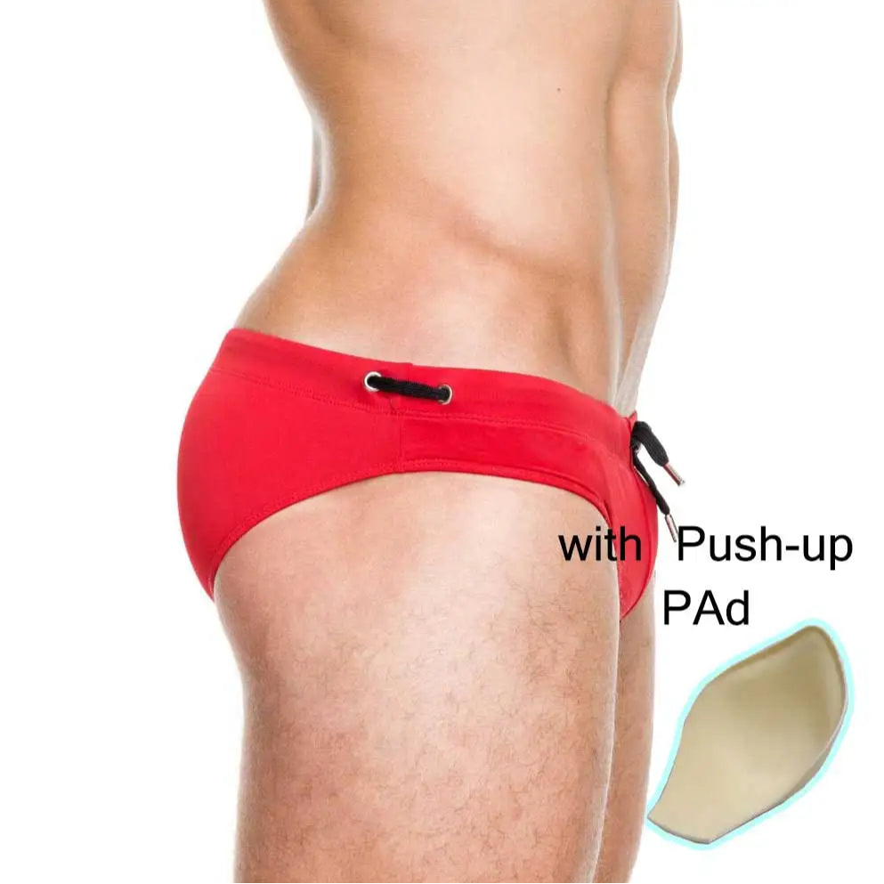 a sexy man in red Men’s Beach Brat Swim Briefs with pad - pridevoyageshop.com - gay men’s sexy swim briefs, trunks, board shorts, and bikinis